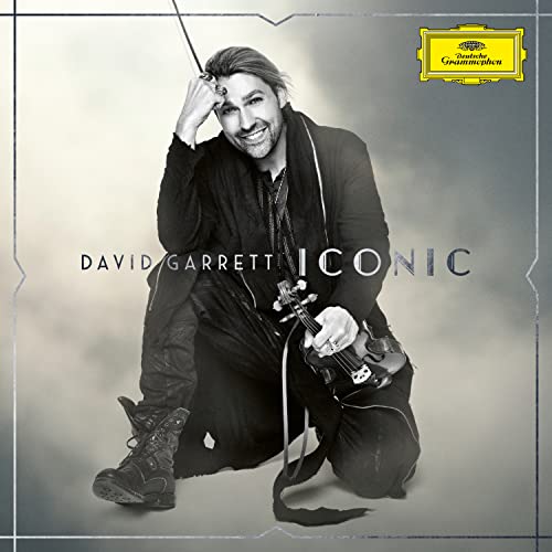 David Garrett sits holding a violin on the album cover "ICONIC".