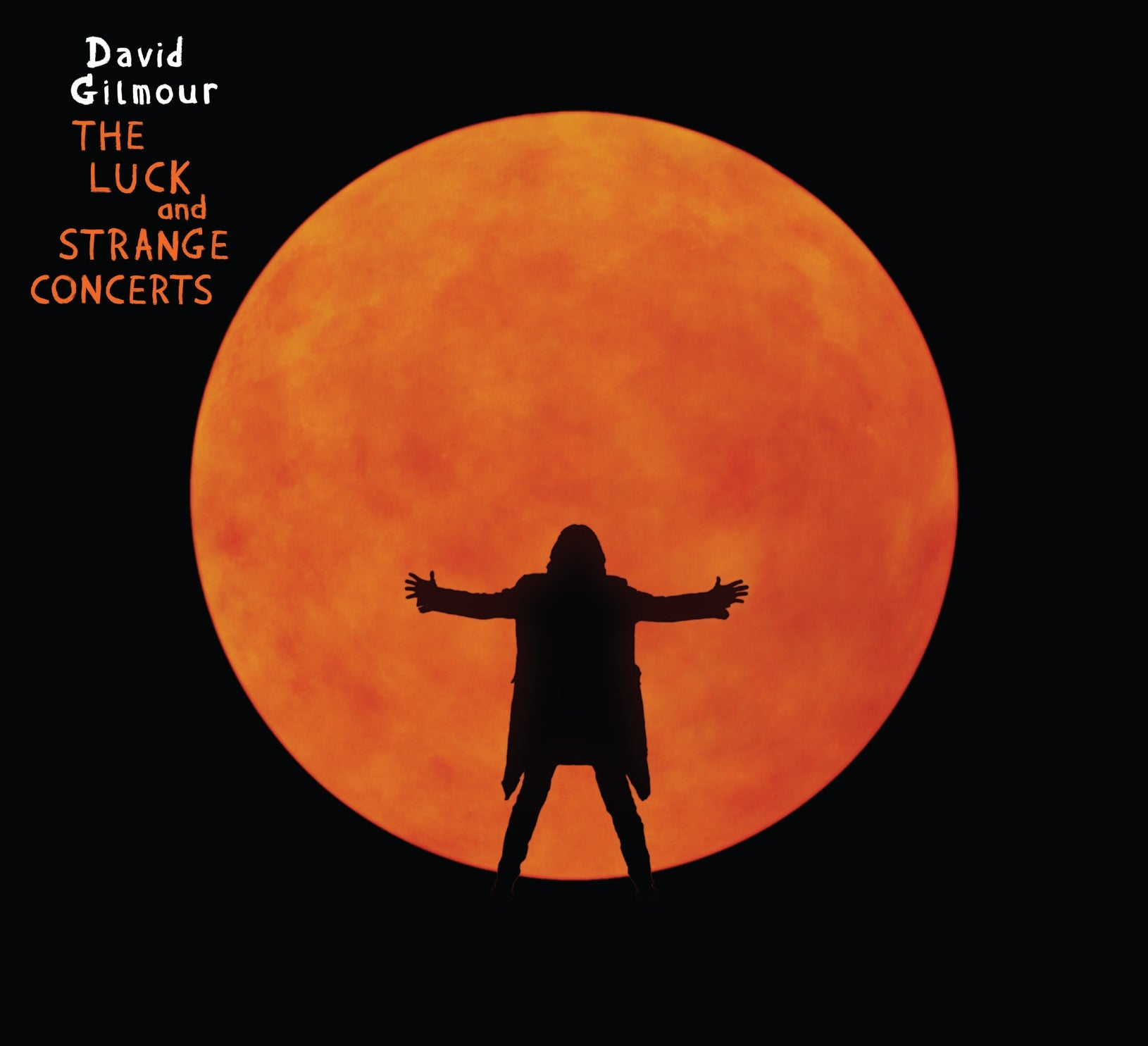 A silhouette of a person with arms outstretched against a large, glowing orange sun.