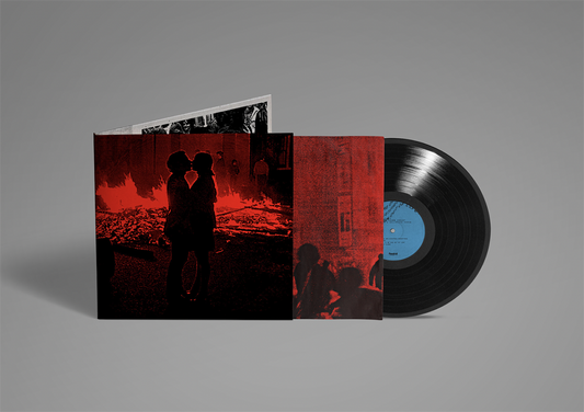 Vinyl record with red album cover featuring silhouetted figures.