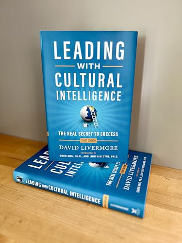 Two copies of the book Leading with Cultural Intelligence by David Livermore on wood.