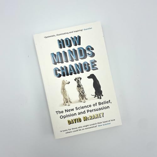 Book cover with title “How Minds Change” and illustrations of three dogs.
