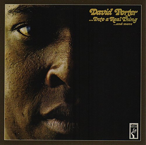 CD cover: close-up of a man’s face, dark background, gold lettering.