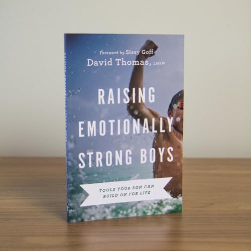 Book cover featuring a boy cheering in water with the title Raising Emotionally Strong Boys.