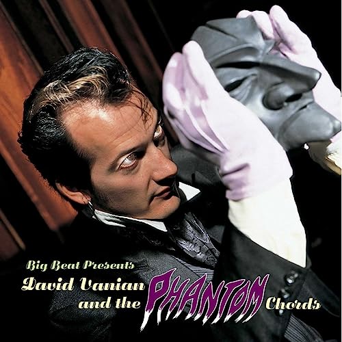 David Vanian holds a Phantom of the Opera-style mask, album cover.