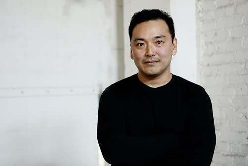 Portrait of a man with dark hair wearing a black shirt.