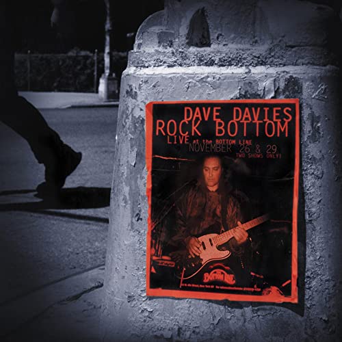 A concert poster for Dave Davies Rock Bottom attached to a stone pillar at night.