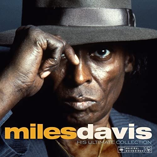 Close-up portrait of Miles Davis in a hat, album cover art.