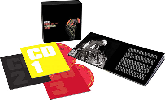 Music album set with CDs and book on white background.