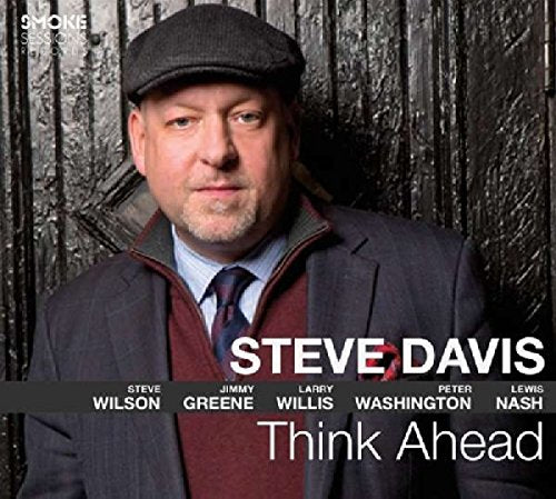 "Album cover featuring a man in a suit and hat, with text overlay."