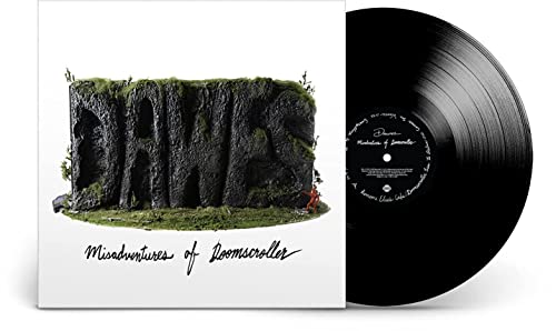 Vinyl record and cover with cliff face and greenery on white background.
