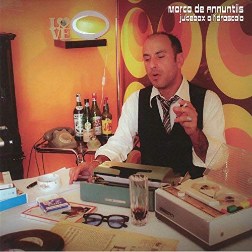 Album cover: Marco De Annuntiis, "Jukebox All'Idroscalo," featuring a man and objects.