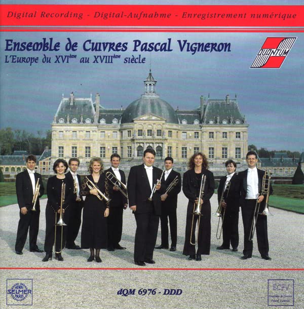 Brass ensemble in formal wear before a large European castle.