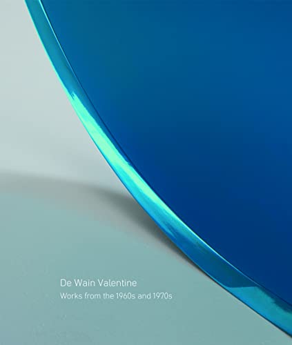 Blue curved resin sculpture on a white surface, book cover detail.