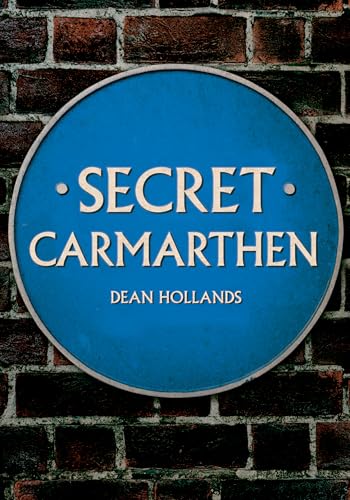 Blue plaque reading "Secret Carmarthen" by Dean Hollands against brick.