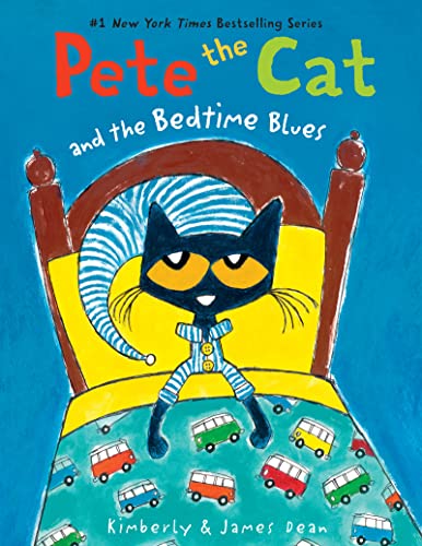 Blue cat in striped pajamas sits on a yellow bed with cars.