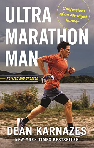 A man in an orange shirt runs along a riverbank under a cloudy sky.
