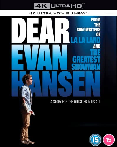A young man stands against a black background with large blue Dear Evan Hansen text.