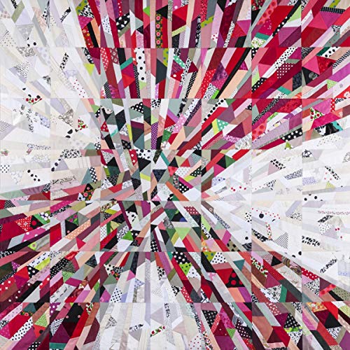 Quilt with a radiating, fragmented pattern in shades of pink, white, and black.