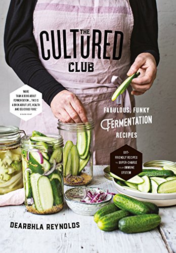 Book cover showing a person in an apron preparing jars of sliced cucumbers.