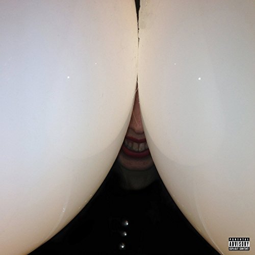 A person with a wide grin peeking between two large, smooth, white curved shapes.