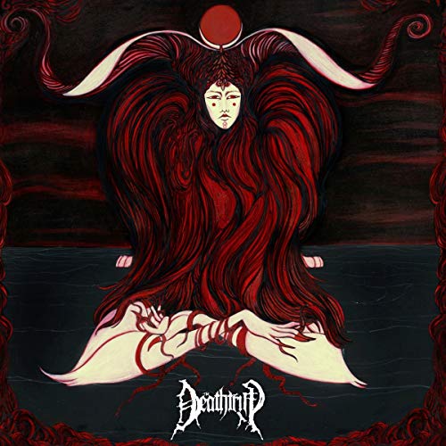 The image depicts a woman with long, flowing red hair sitting cross-legged.
