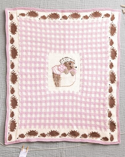 Knitted baby blanket with a pink gingham pattern, hedgehog border, and central hedgehog motif.