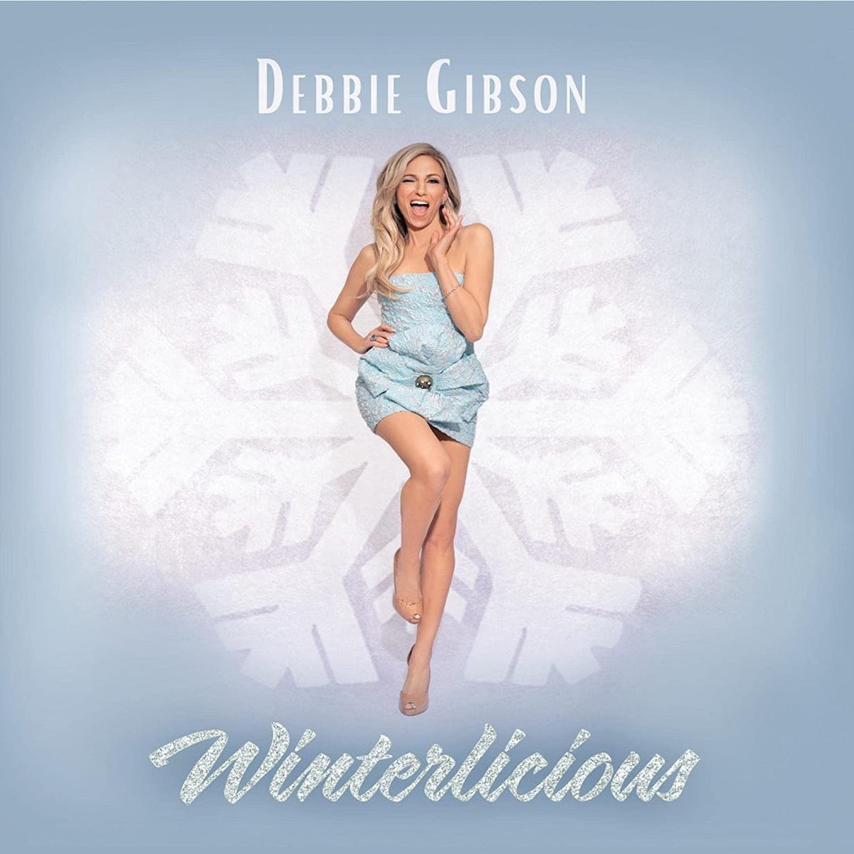 Debbie Gibson album cover, "Winterlicious," featuring a smiling woman in blue.