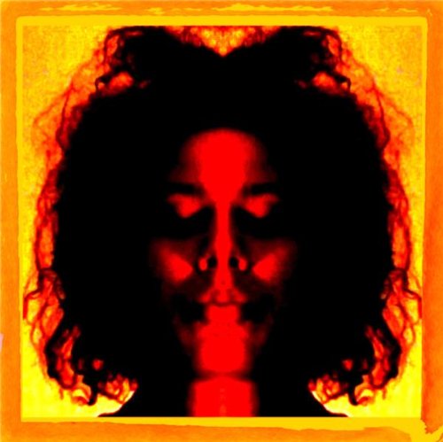 The alt text for the image is: "A woman's face in red and yellow tones."