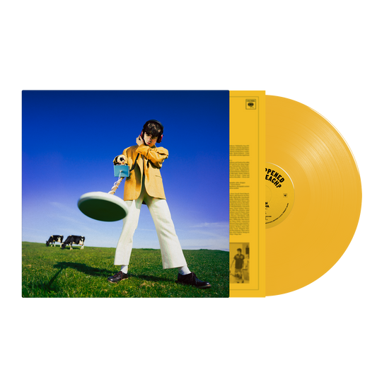 Declan McKenna album cover with a person in yellow, vinyl record beside.