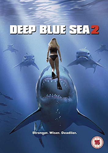 A woman swims above a large shark with an open mouth in deep water.