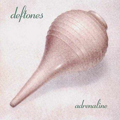 Vinyl record with white cover featuring a seashell and "Deftones Adrenaline" text.