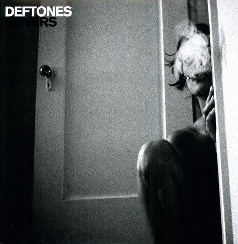 Black and white album cover with a person framed in a doorway.