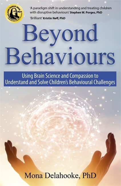 Book cover titled Beyond Behaviours showing cupped hands holding a glowing, digital-style human brain.