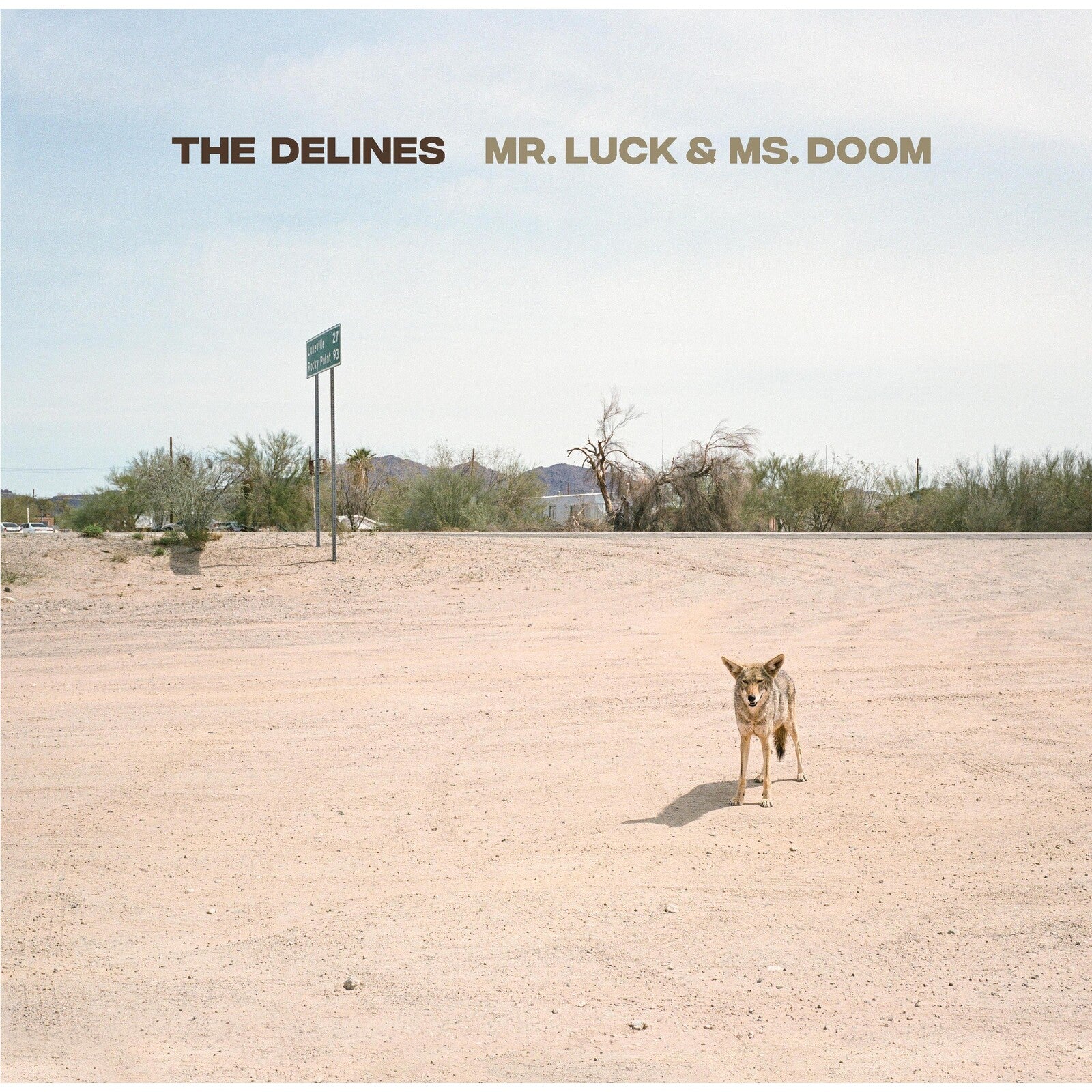 Album cover: coyote standing on a dusty road with desert landscape.