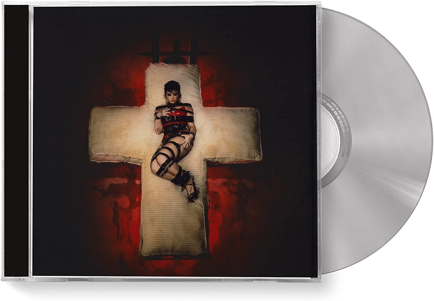 Demi Lovato lying on a cross, wearing red and black lingerie, against a dark red background.