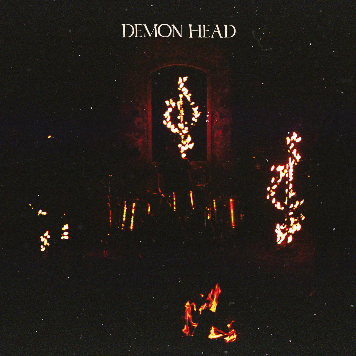 Dark album cover with a window-shaped light pattern and "Demon Head" text.