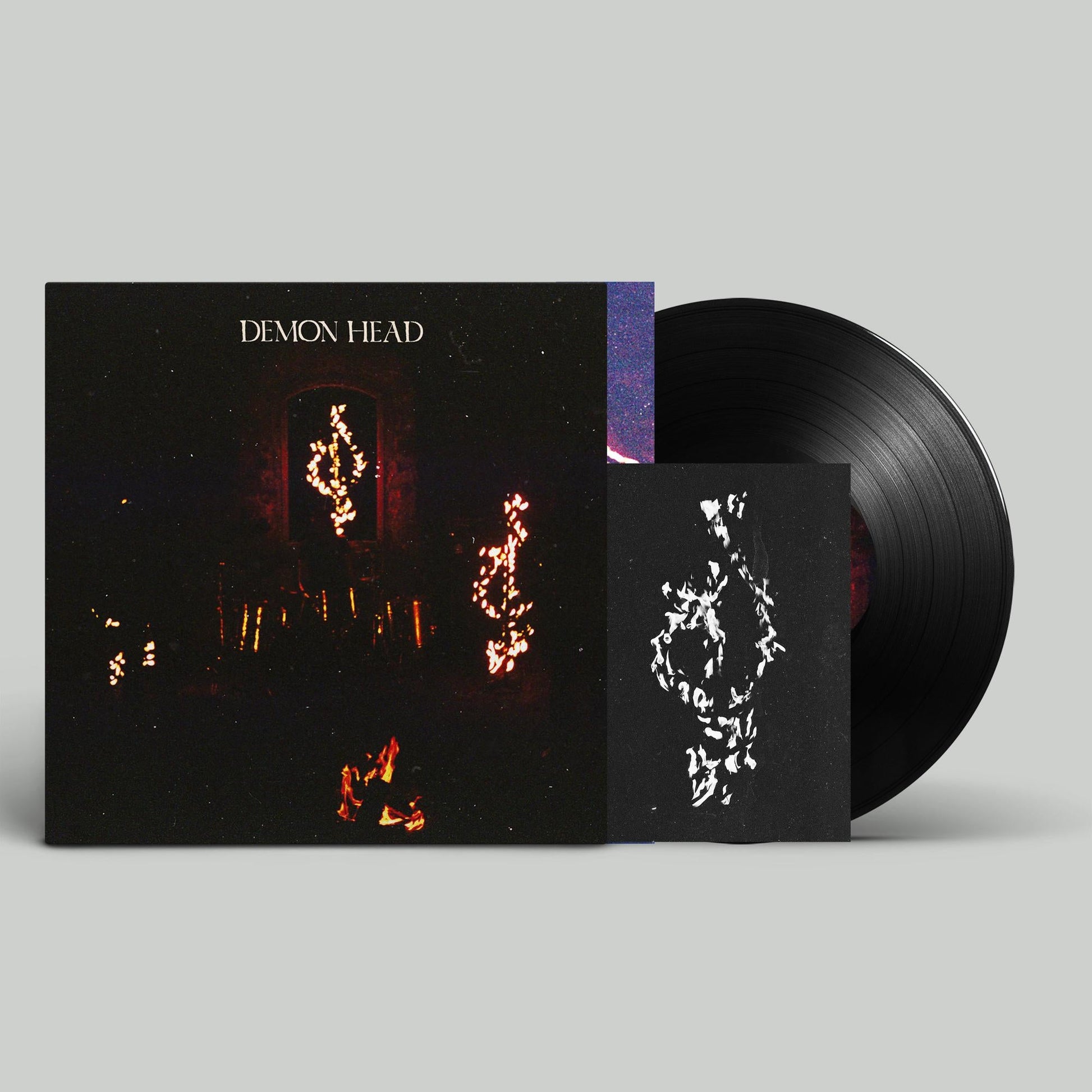 Vinyl record and cover art featuring a dark, starry, demonic image.