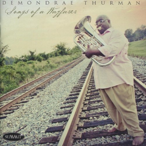 CD cover: Demondrae Thurman playing a sousaphone by railroad tracks.