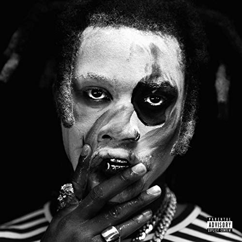 Black and white portrait of Denzel Curry with dark face paint.