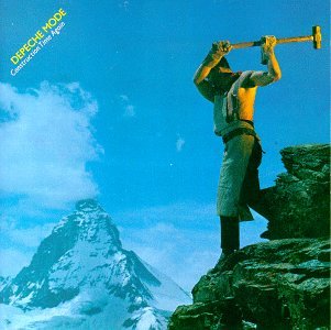 Depeche Mode album cover: man with pickaxe on a rocky peak.