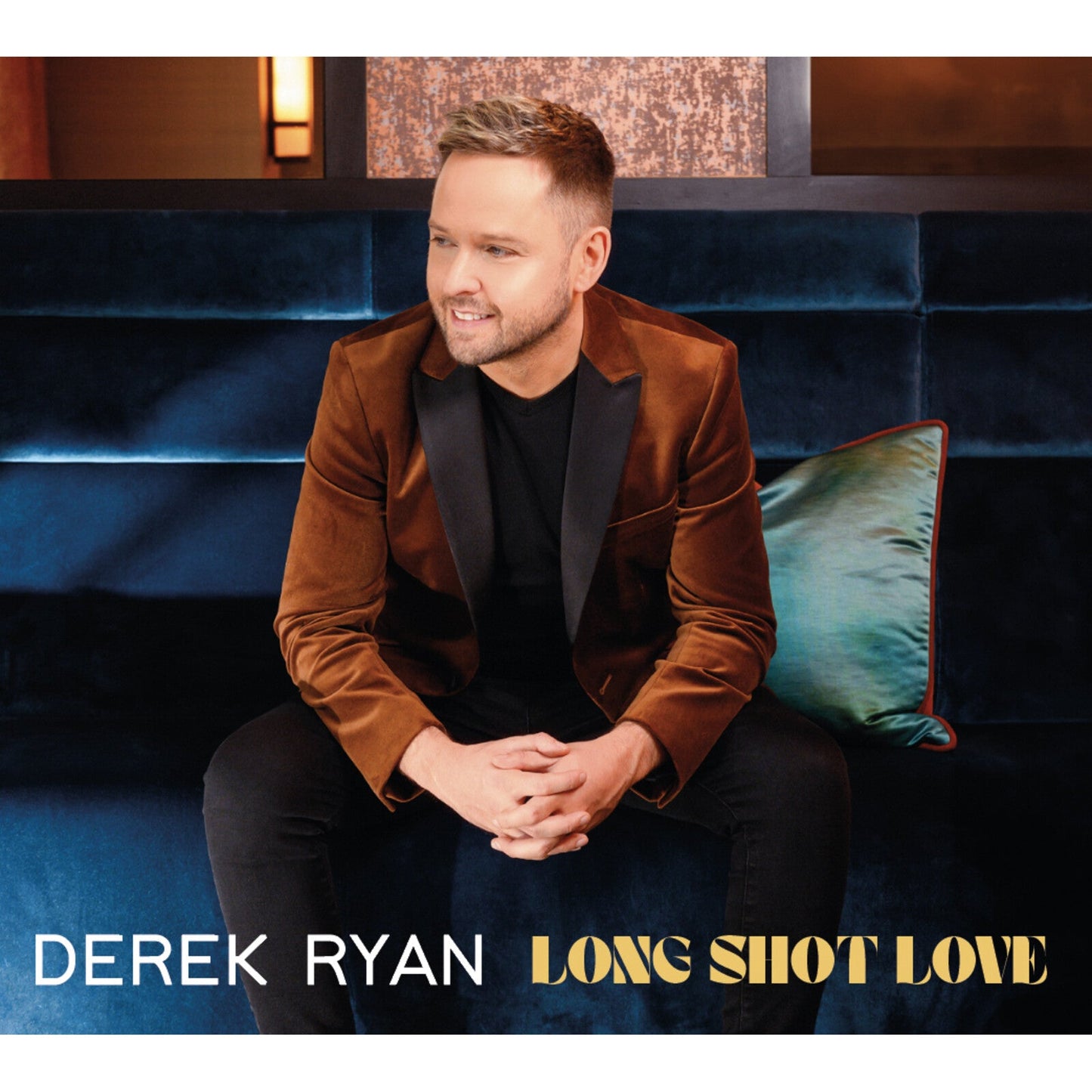 Derek Ryan album cover, man in brown velvet suit smiling.