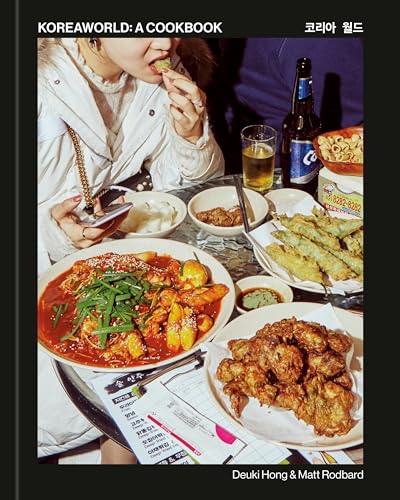 Cookbook cover featuring a person eating and a table spread of Korean dishes.