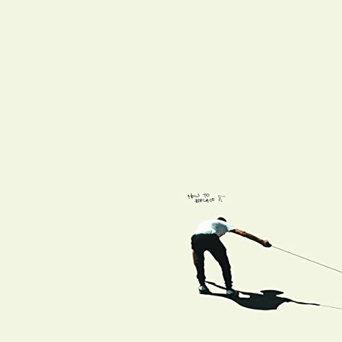 Album cover: man bending backwards holding a rope, pale background.