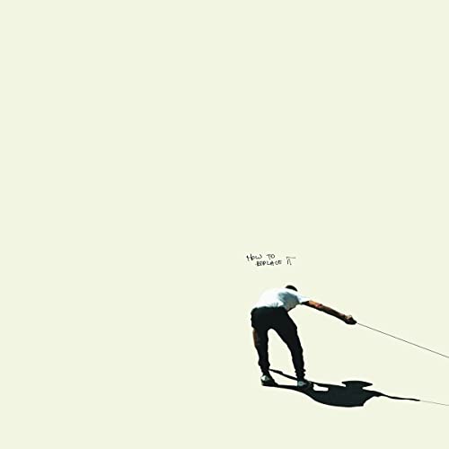 Album cover: man bending backwards, holding a rope, against a pale background.
