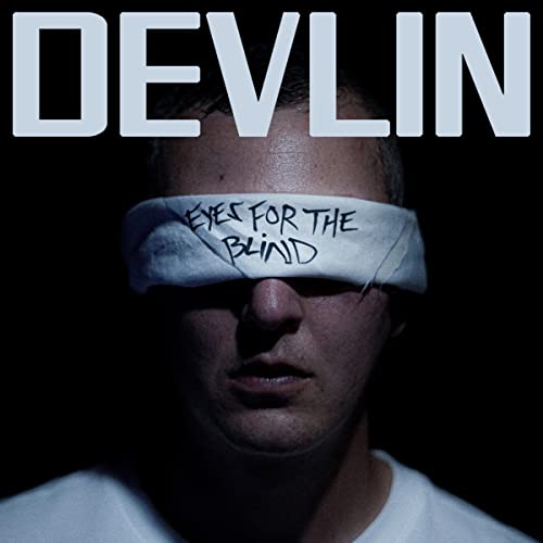 Album cover featuring a man blindfolded with a cloth reading Eyes For The Blind.