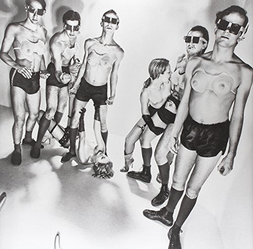Black and white photo of Devo band members in quirky outfits and sunglasses.