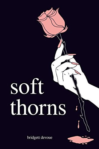 A hand with pink nails holds a pink rose against a dark background.