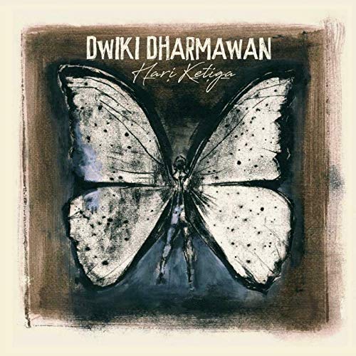 CD cover with butterfly wings and a silhouetted figure inside.