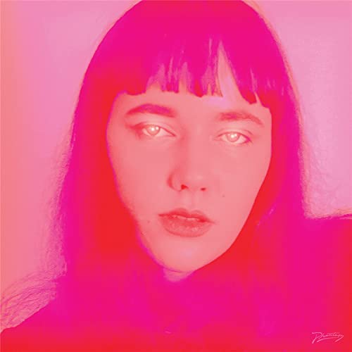 Close-up of a woman with dark hair, in a vibrant pink and red image.