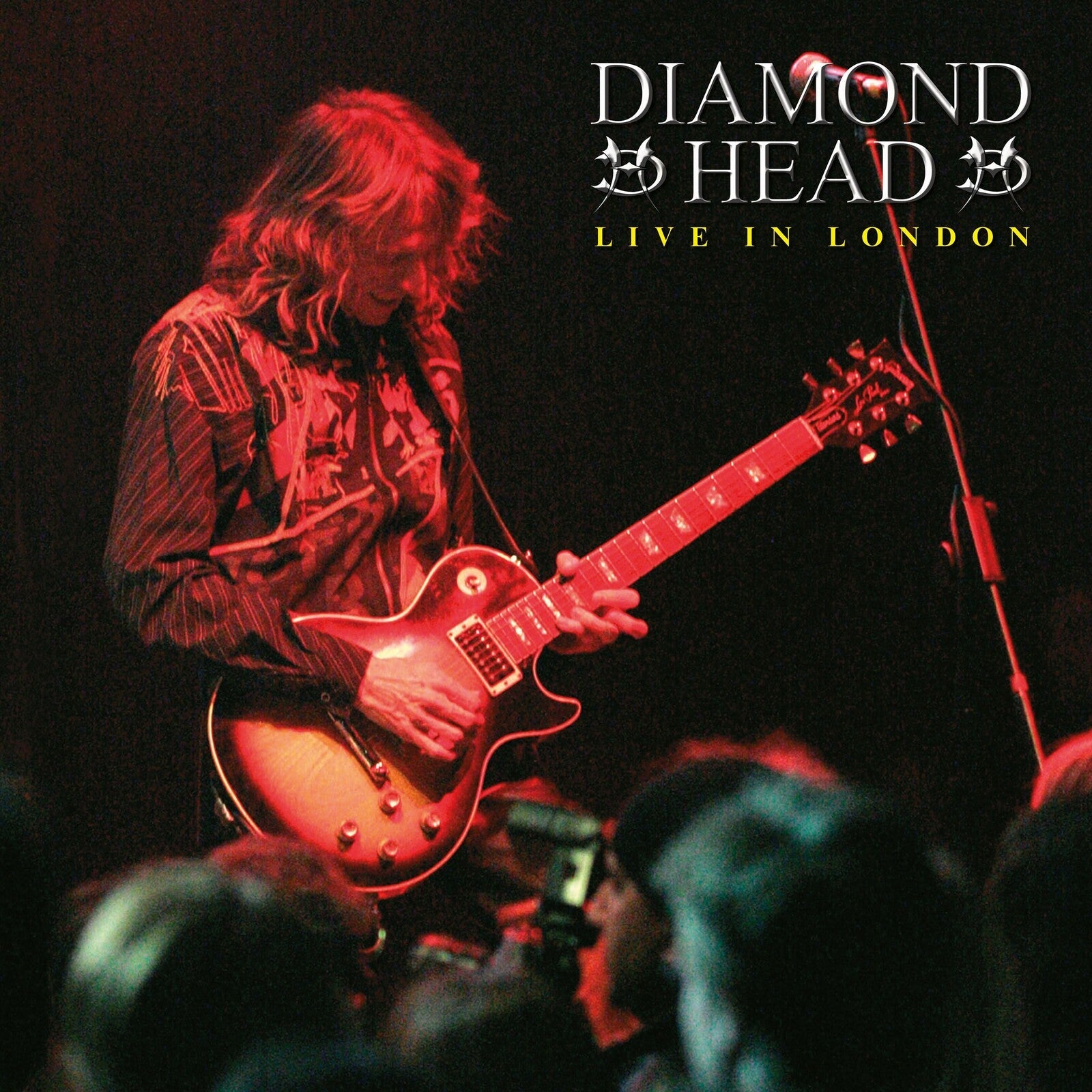 Diamond Head album cover featuring a guitarist playing a red electric guitar.